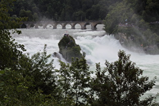 Zoom auf den Rheinfall, etwa in Bildmitte der Große Rheinfallfelsen, und die Rheinfallbrücke