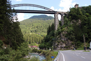 Blick über die Trisanna flussabwärts auf Trisannabrücke, dahinter Wasserkraftwerk Wiesberg, Arlberg Ersatzstraße im Hang, und Schloss Wiesberg